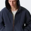 Lässige Bomberjacke mit Kapuze – gewaschenes Marineblau Lässige Bomberjacke mit Kapuze – gewaschenes Marineblau