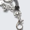 Schlüsselanhänger mit mehreren Anhängern – Metall/schwarze Schnur Schlüsselanhänger mit mehreren Anhängern – Metall/schwarze Schnur